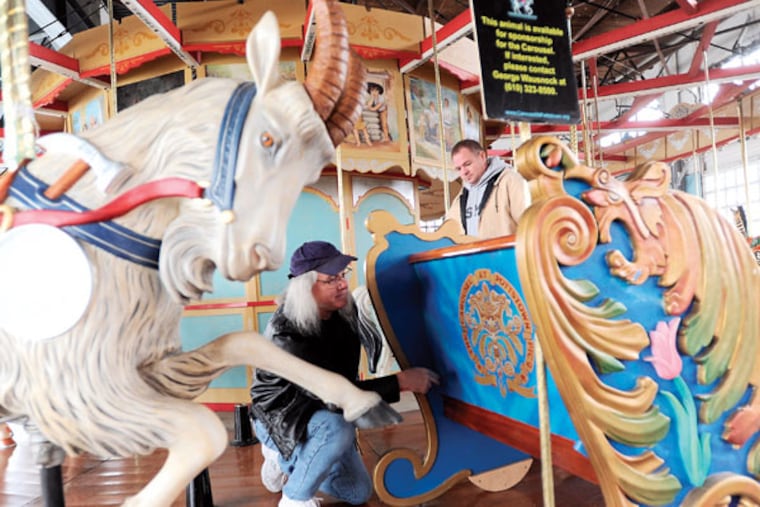 Chief mechanic Don Arters, right, and art director Alan MacBain review the recent installation of a new ride on the historic carousel Thursday, Dec. 11, 2014, in Pottstown.