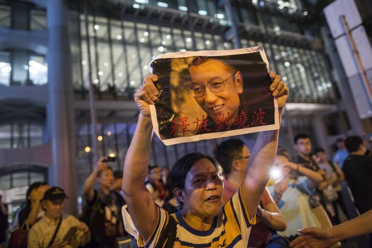 Protesters hold candles, demanding the release of the Nobel Peace Prize winner Liu Xiaobo on June 29 in Hong Kong. Liu Xiaobo died Thursday at the age of 61.