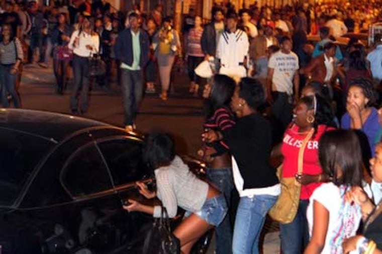 Young people swarmed South Street in a flash mob incident the night of March 20. ((Laurence Kesterson / Staff Photographer)