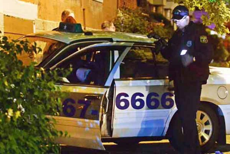 Staff photos by Tom Kelly IV
Philadelphia Police investigate the fatal shooting of a taxi cab driver in West Philadelphia, early Wednesday morning, May 8, 2013. The shooting occurred near the intersection of W. Walnut Street and Cobbs Creek Parkway, and according to police was the result of an armed robbery attempt. The cab driver, who was in his 30's was taken to HUP where he later died from his injuries. The cab driver tried to pull away from the robber, and was shot multiple times before striking a vacant house with his vehicle.