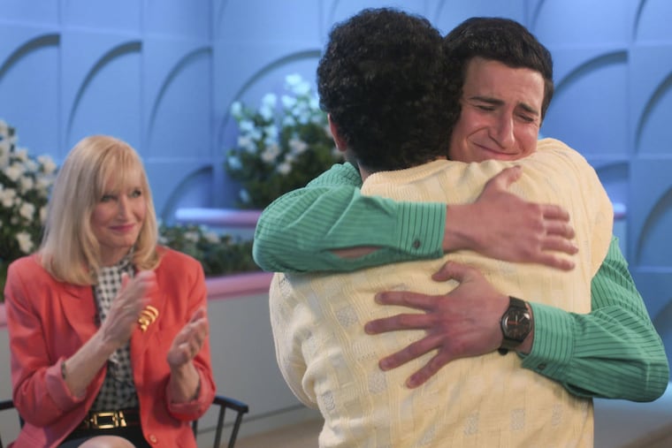 Troy Gentile (in yellow) and Sam Lerner hug as Philadelphia's Nancy Glass (left) looks on in the March 24 episode of ABC's "The Goldbergs," in which Glass plays herself as a 1980s talk show host.