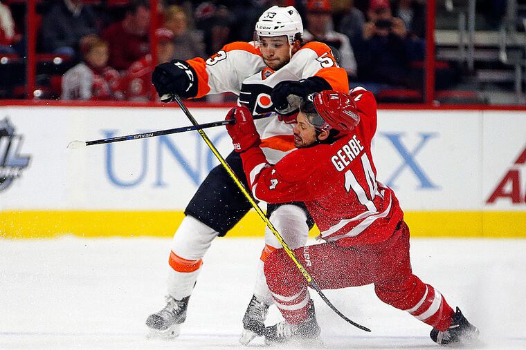 Hurricanes forward Nathan Gerbe collides with Flyers defenseman Shayne Gostisbehere.