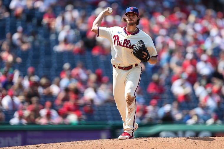 Philadelphia Phillies starting pitcher Aaron Nola (27) throws to first during the fifth inning of the Philadelphia Phillies game against the Cincinnati Reds at Citizens Bank Park in Philadelphia, Pa. on Sunday, August 15, 2021.
