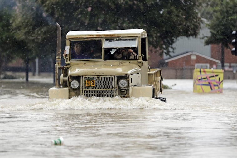 A truck pushes through floodwaters from Tropical Storm Harvey Sunday, Aug. 27, 2017, in Houston, Texas.