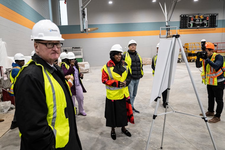 Mayor Jim Kenney and Mayor-elect Cherelle Parker (center) on a hard-hat progress tour of the $21 million reconstruction of the Vare Recreation Center in South Philly.