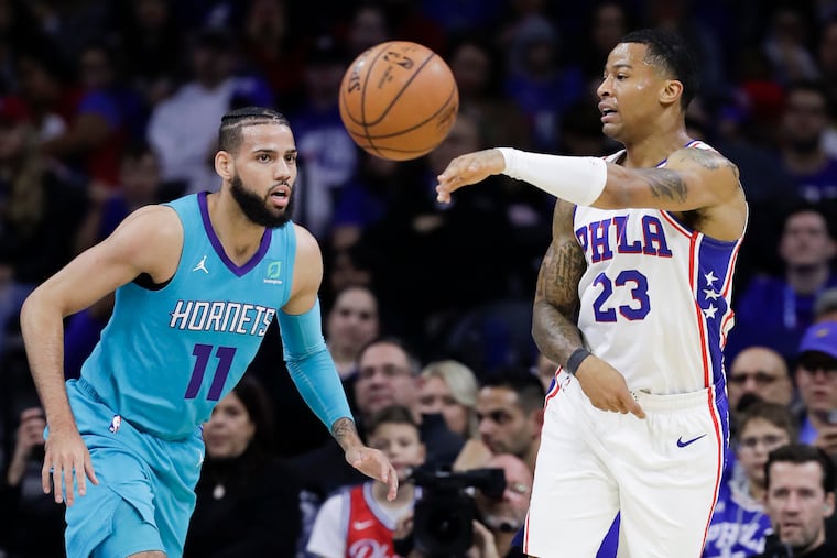 Sixers guard Trey Burke passes the basketball past Charlotte Hornets forward Cody Martin on Sunday.