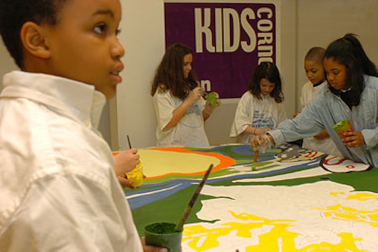 Students painting a mural at the Penn Alexander School. The University of Pennsylvania helped to build and fund the public school. (Tiffany Yoon / Staff Photographer)