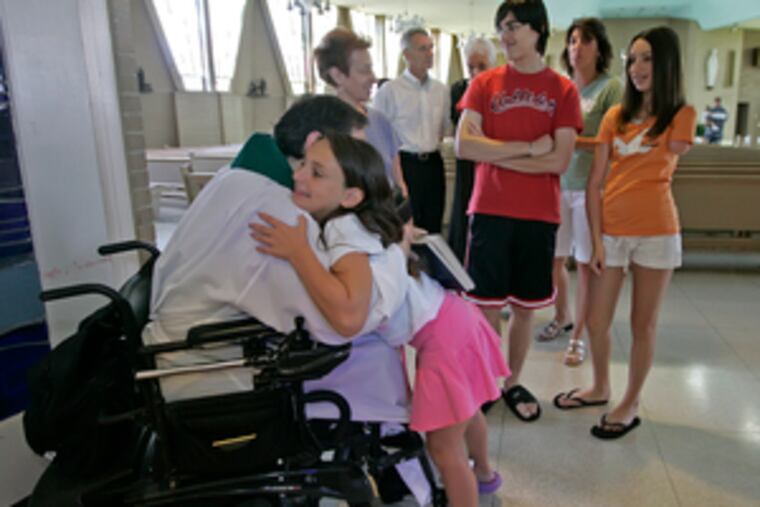 Tori D'Amico received a birthday blessing from Msgr. Marucci. St. Vincent Palotti has extra-wide aisles and other features that accommodate disabled people.