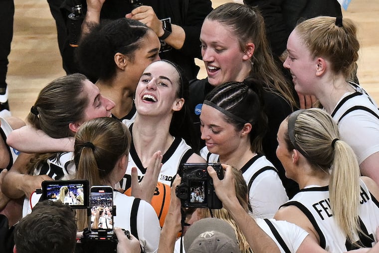 Caitlin Clark (center) celebrates with her Iowa teammates after their win over LSU.