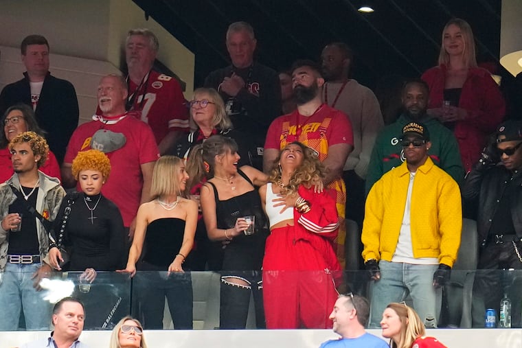 Taylor Swift, bottom middle, and Blake Lively laugh before the Super Bowl. Jason Kelce in the row behind them with his parents.