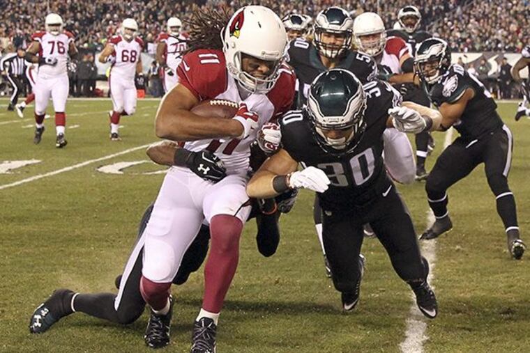 Larry Fitzgerald catches the football against the Eagles’ Ed Reynolds in the first-quarter on Sunday, December 20, 2015 in Philadelphia. ( YONG KIM / Staff Photographer )