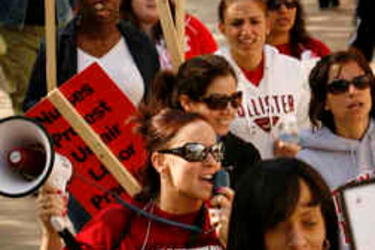 Striking workers picket outside Temple University Hospital. Tuition reimbursement, pay, and scheduling are at issue.