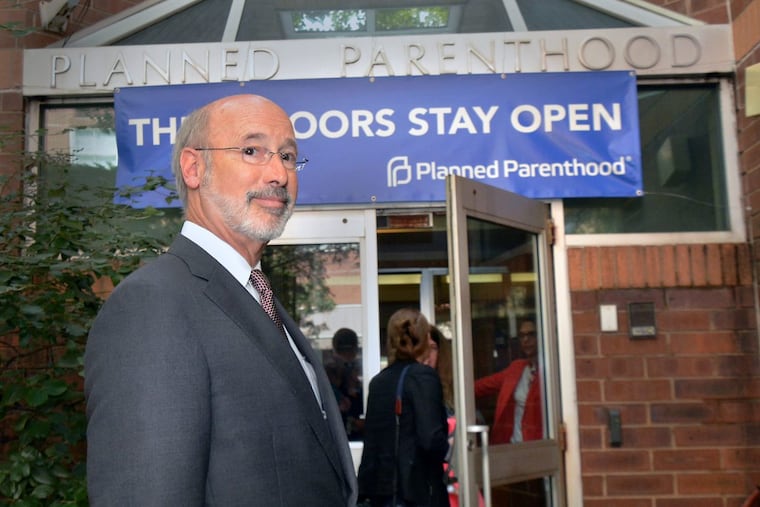 Gov. Wolf pauses outside the Elizabeth Blackwell Health Center on Locust Street during his visit Thursday.