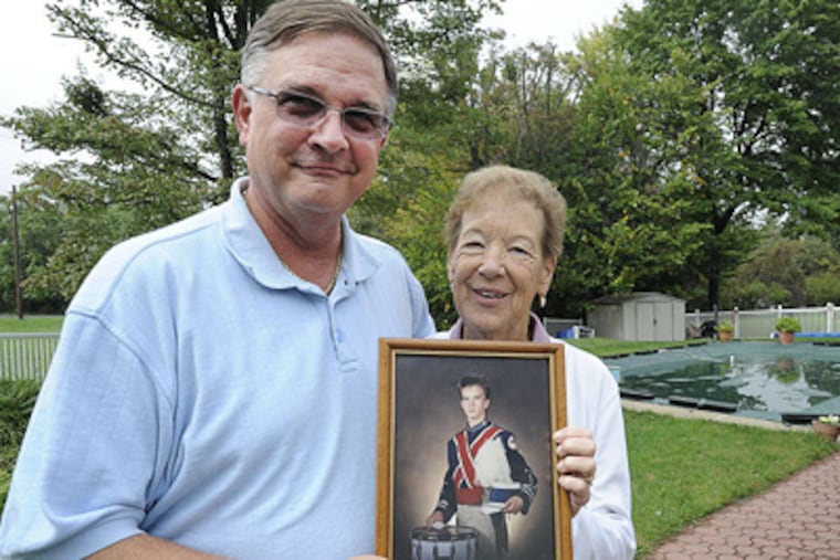 Ed and Mary Stimson of Plymouth Meeting, whose son Keith (in portrait) was killed in 1987, will judge a band competition in Whitemarsh Township and bestow an award in his memory. SHARON GEKOSKI-KIMMEL / Staff Photographer