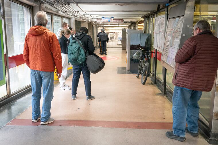 People wait at the Eighth and Market PATCO station after service was suspended on April 5 because of the earthquake.