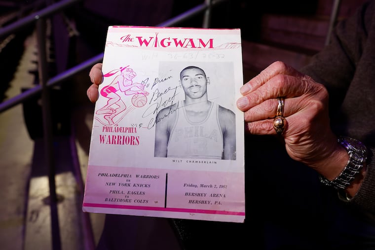 Sixers stat crew leader Ron Pollack holds the autographed program of the game in which Wilt Chamberlain scored 100 points.