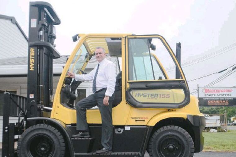 Modern Group CEO Paul Farrell, on a Hyster 155 Fortis Forklift for sale. While forklift sales dropped with the recession, stormy weather helped increase sales of generators and wood chippers. (Viviana Pernot / Staff Photographer)