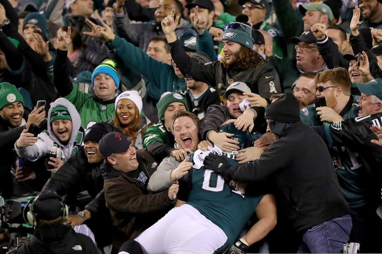 Eagles guard Stefen Wisniewski pulls off a Linc Leap into the crowd after Alshon Jeffery's fourth-quarter touchdown. DAVID MAIALETTI / Staff Photographer