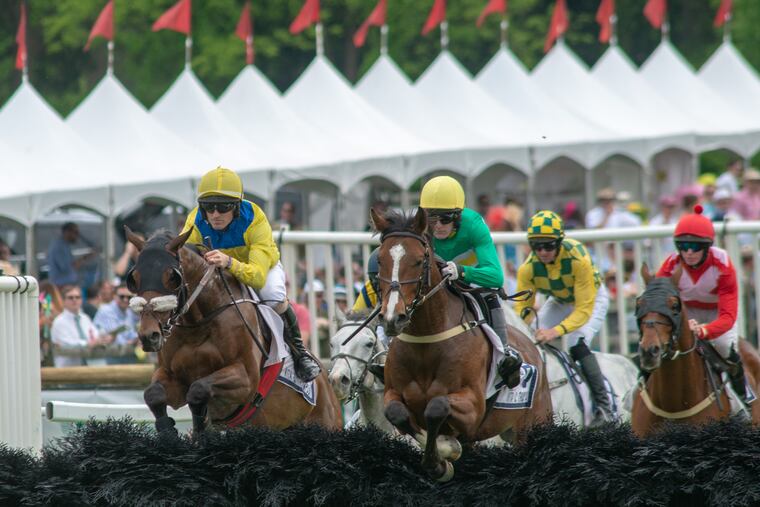 Kieran Norris (left) rides Kensington Court, and Graham Watters rides Stormy Alex as they jump a hurdle in the Thompson Memorial race.