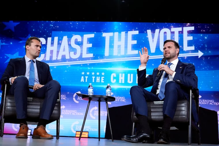 Republican vice presidential nominee Sen. JD Vance, R-Ohio, right, speaks at a campaign event as conservative podcaster Charlie Kirk listens in September 2024, in Mesa, Ariz.