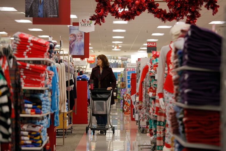 In this Nov. 27, 2019, filephoto Robin Hazal shops at a Kohl's ahead of Black Friday in Las Vegas. New data on U.S. retail sales will provide another view of how the holiday shopping season is going. Economists predict the Commerce Department will report Friday that retail sales rose 0.4% in November.