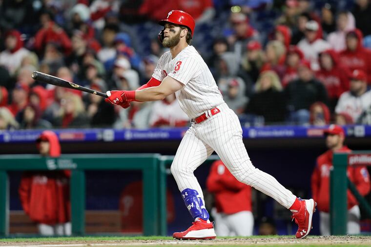 Bryce Harper watches his third-inning double during the Phillies' win on Sunday.