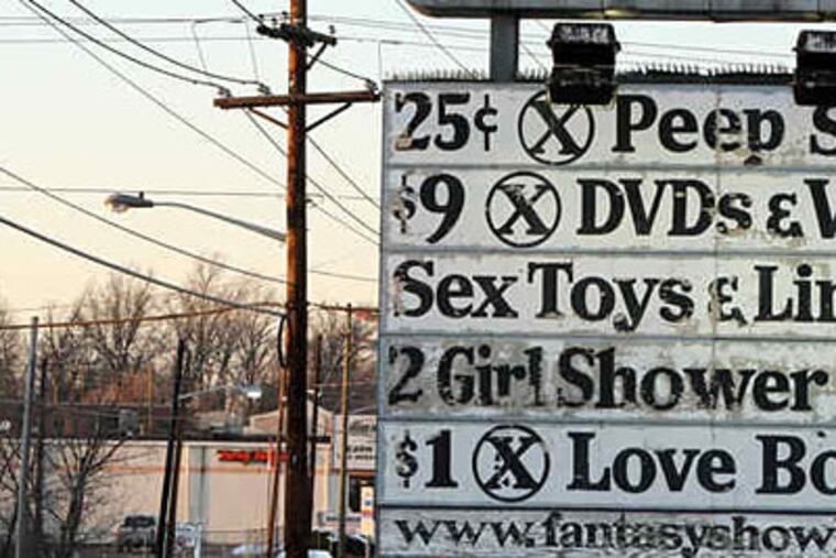 The Fantasy Showbar and its enormous advertisements have become an uncomfortable landmark for this working class town. (STEVEN M. FALK / Staff Photographer)