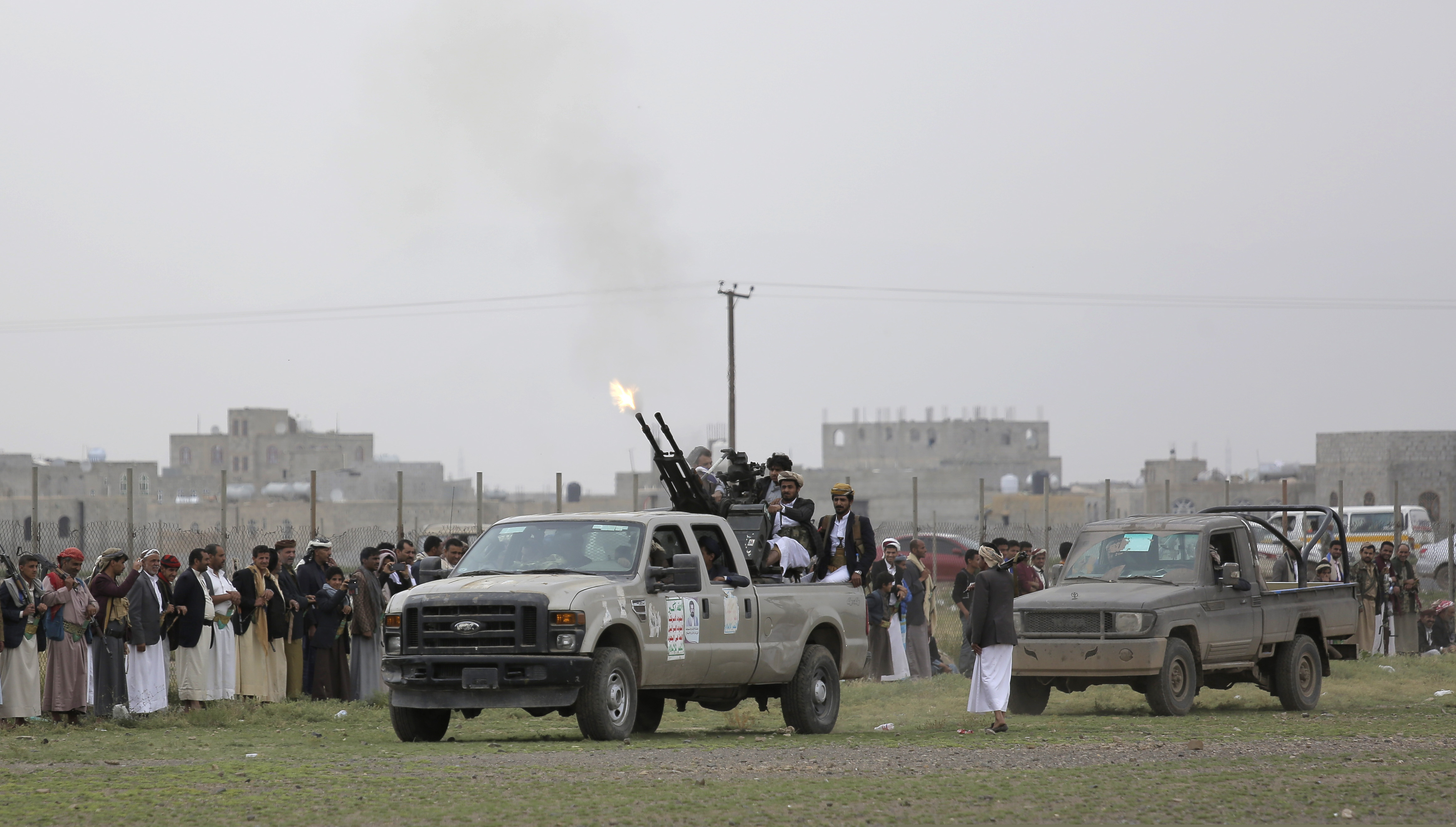 Houthi rebel fighters fire their weapons in the air as they take off to a battlefront following a gathering aimed at mobilizing more fighters for the Houthi movement, in Sanaa, Yemen, Thursday, Aug. 1, 2019. The conflict in Yemen began with the 2014 takeover of Sanaa by the Houthis, who drove out the internationally recognized government. Months later, in March 2015, a Saudi-led coalition launched its air campaign to prevent the rebels from overrunning the country's south.