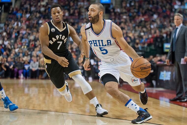 Philadelphia 76ers guard Kendall Marshall (5) dribbles past Toronto Raptors guard Kyle Lowry (7) in the second quarter at Air Canada Centre.