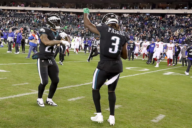 Philadelphia Eagles running back Miles Sanders (left) and wide receiver Zach Pascal (right) dance on the field after the Eagles win 22-16 over the Giants at Lincoln Financial Field on Sunday, Jan. 8, 2023, in Philadelphia, PA. The win secured the top seed for the Eagles in the NFC playoffs.