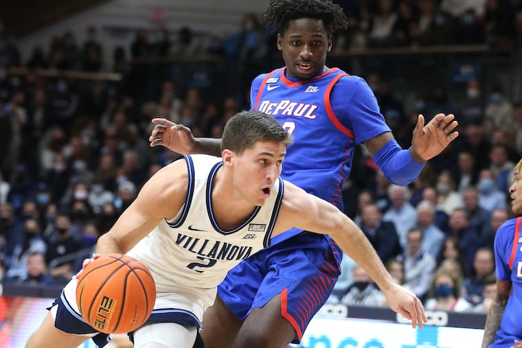 Collin Gillespie of Villanova drives past David Jones of DePaul during the first half at Finneran Pavilion.