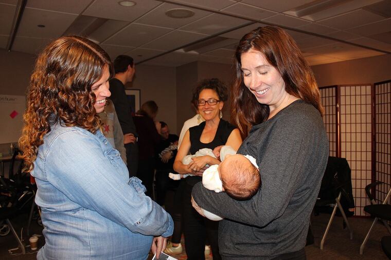 Andrea Moffat (left) admires Kate Galecki's newborn daughter at a session of CenteringPregnancy at Northwestern Medicine in Chicago. Over the past five years, the number of practices that offer the program has nearly doubled.