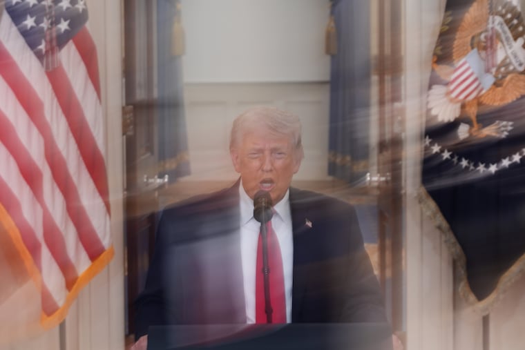 In this image made with a long exposure, President Donald Trump speaks about the Iran war from the Cross Hall of the White House on Wednesday.