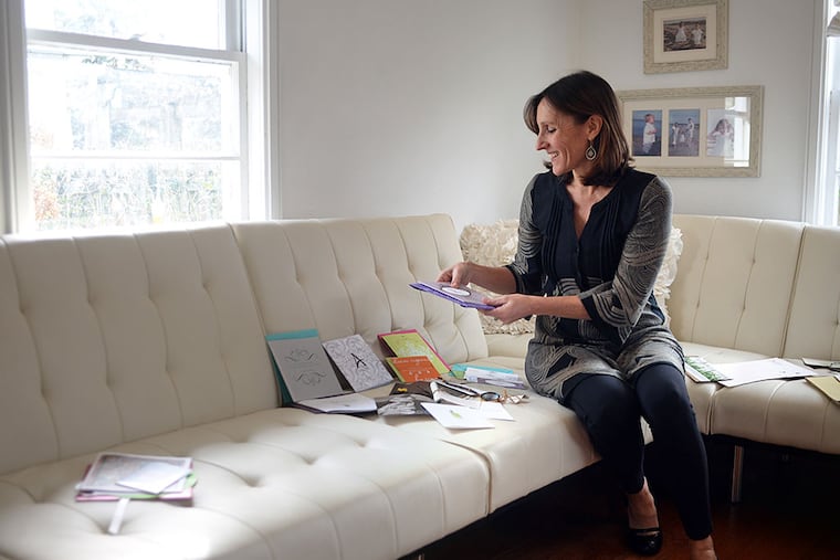 Doylestown's Kim Bensing in her design studio. Her priority, she says, is helping clients make milestone events more memorable. TOM GRALISH / Staff Photographer
