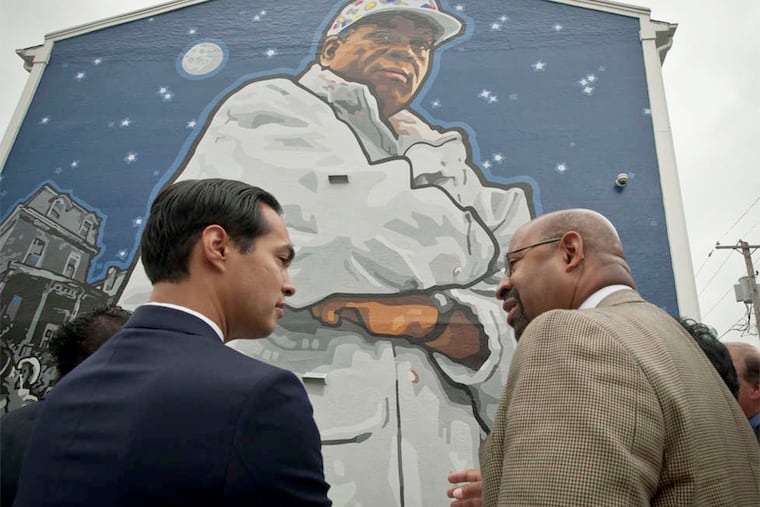 Mayor Nutter explains the Mural Arts Program to HUD chief Julián Castro in front of the Herman Wrice mural.