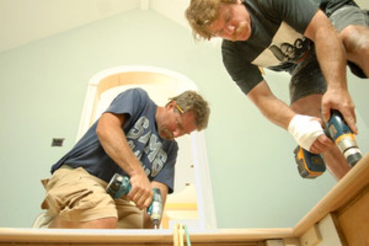 Long Beach Island homeowner Dan Smith (left) and designer Forrest M. Shackelton work on Smith's Holgate home. Though some supplies have become expensive, relief may be in sight as commodity speculators rush for better opportunities.