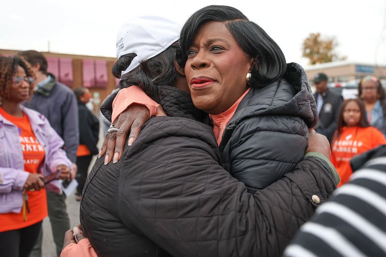 Democratic mayoral nominee Cherelle Parker hugs a supporter at a get-out-the-vote motorcade three days before Election Day.