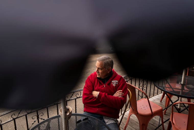 District Attorney Larry Krasner drinks coffee outside of Gleaner’s Cafe before shopping for groceries in the Italian Market on March 8 in South Philadelphia.