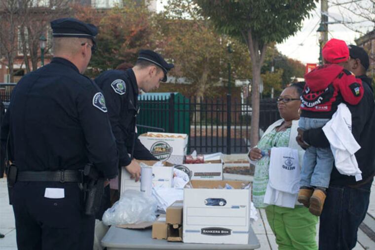 Camden residents stop by one of the tables set up in the city. (Randi Fair / Staff Photographer)