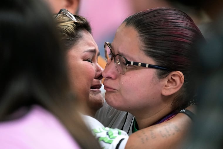Felicia Martinez, left, and Evadulia Orta, right, both whose children were among 19 children killed in the massacre at Robb Elementary, embrace after speaking at a special city council meeting in Uvalde, Texas.