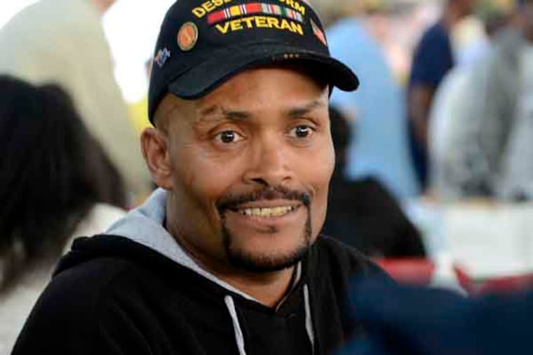 Mark Briley, 50, of Philadelphia talks with Ayanna Garrett with the Phila. V.A. Medical Center about his health benefits for services at Stand Down 2013, at the National Guard Armory in Cherry Hill September 27, 2013. He served with the U.S. Army in first Gulf War from 1991-1992. Sponsored by the New Jersey Department of Military and Veterans Affairs and the Stand Down of South Jersey Committee, the annual event provide homeless veterans with access to healthcare, mental health screening, substance abuse counseling, social services (food stamps and unemployment), legal services, religious counseling, a hot meal, a haircut and winter clothing. ( TOM GRALISH / Staff Photographer )