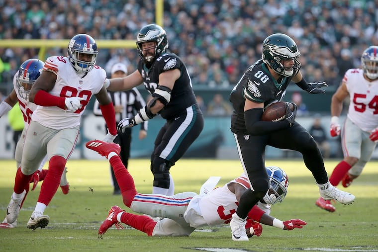 Dallas Goedert outruns a tackle attempt by Giants cornerback Curtis Riley.