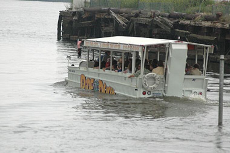 A Ride The Ducks boat drives into the river at Race Street and Delaware Avenue. (Krystle Marcellus / Staff Photographer)
