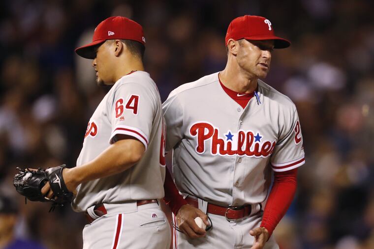 Gabe Kapler ushers relief pitcher Victor Arano off the mound during the fifth inning of Wednesday's loss.