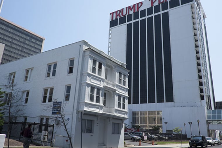 The empty, boarded up Vera Coking home sold at auction for $530,000 to an anonymous bidder. (Ed Hille / Staff Photographer)