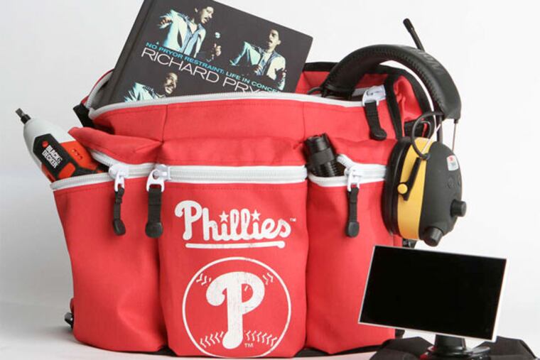 STEPHANIE AARONSON / STAFF PHOTOGRAPHER A whole kit-load of stuff for dad on his day, handily held by the Diaper Dude Phillies Bag.