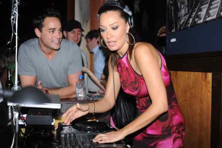 DJ Sky Nellor, with VH1 matchmaker Steven Ward, spins at the Public House at 18th and Arch Streets. The party Thursday celebrated the restaurant's fourth anniversary.