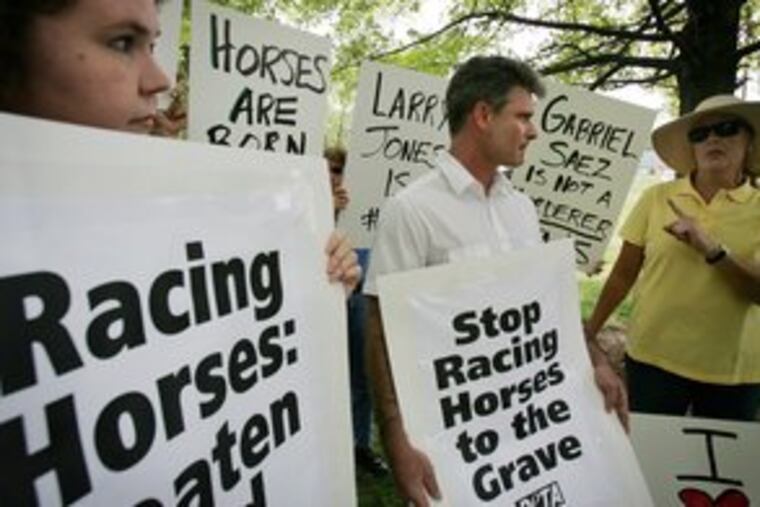 Protesters Kelli O'Brien (left) and Tom Crain and supporter Laura Koester argue outside the Kentucky Horse Racing Authority's headquarters in Lexington, Ky. The rally was prompted by Eight Belles' death.