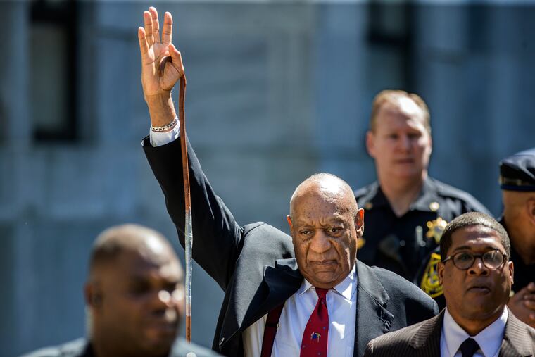 As Bill Cosby, center, leaves the Montgomery County Courthouse, he raises his arm in recognition to the crowd noise as he made his way to his SUV, after being found guilty on all three counts of sexual assualt during his retrial in Norristown, PA, on Thursday April 26, 2018. MICHAEL BRYANT / Staff Photographer