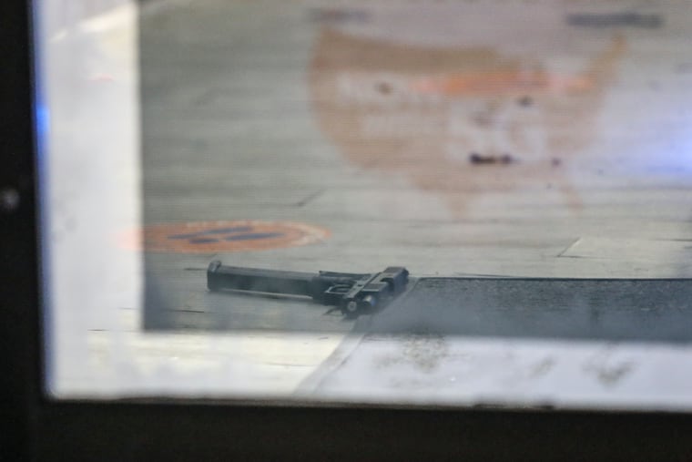 Police at the scene of a phone store, Techish, in the 2600 block of Germantown Avenue in North Philadelphia where a man was fatally shot Tuesday night. A handgun can be seen just inside the front door.